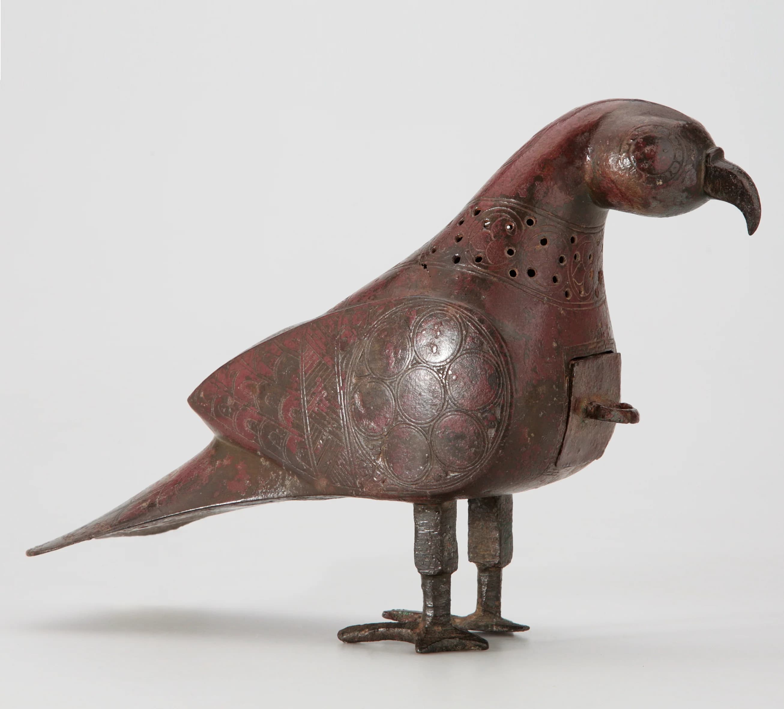 A KHORASSAN COPPER INLAID BRONZE INCENSE BURNER IN THE FORM OF A DOVE
