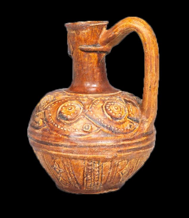 A RARE UMAYYAD / EARLY ABBASID MONOCHROME MOULDED POTTERY JUG