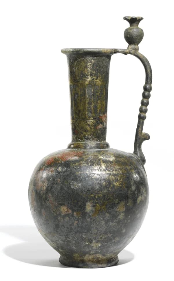 AN UMAYYAD OR EARLY ABBASID BRONZE EWER