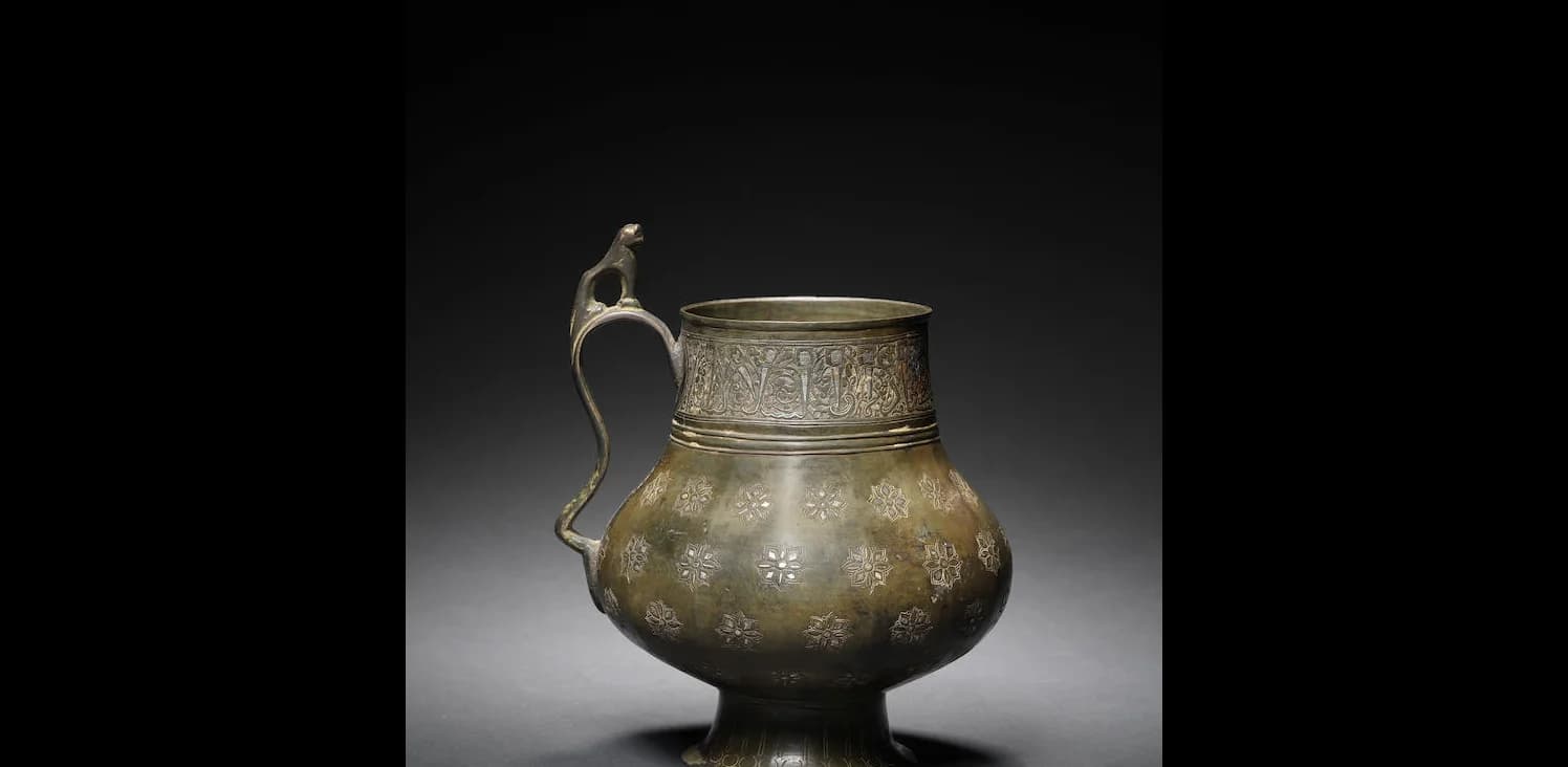A KHORASAN SILVER INLAID BRONZE JUG (KUZE)