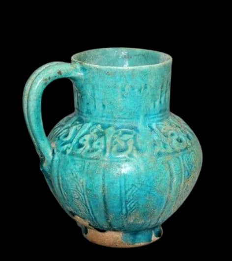 A TURQUOISE-BLUE GLAZED POTTERY JUG